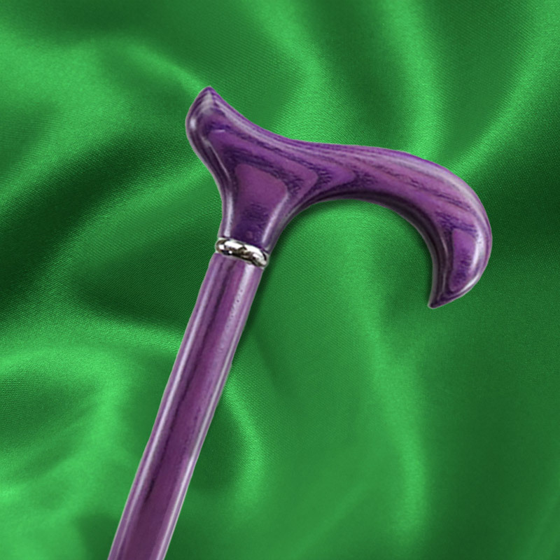 a purple walking stick against a silky green material